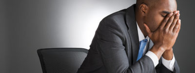 Businessman with head in hands